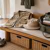 Explorer-style child costume vest, soft hat, shoes and open bag on a home entryway bench
