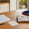 Blank school notice, pencil and Book Week costume pieces on a table