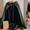School jumper, green cape and black school shoes arranged for a Book Week costume