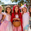 Group of girls in Book Week costumes - fairy, princess, red riding hood, unicorn and cat