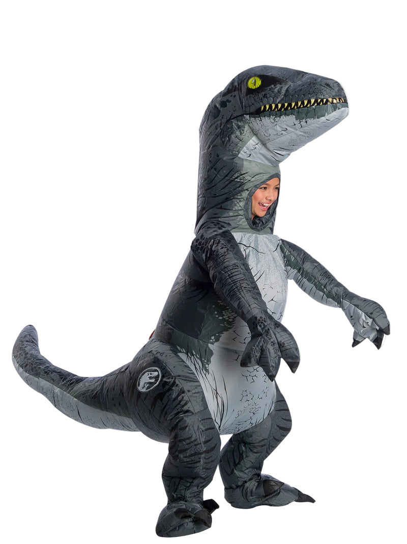 Child wearing Velociraptor Blue inflatable costume from Jurassic World, showing metallic blue stripe and oversized dinosaur head
