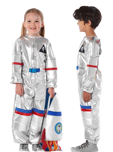 Child wearing silver astronaut costume with rocket backpack standing against white background
