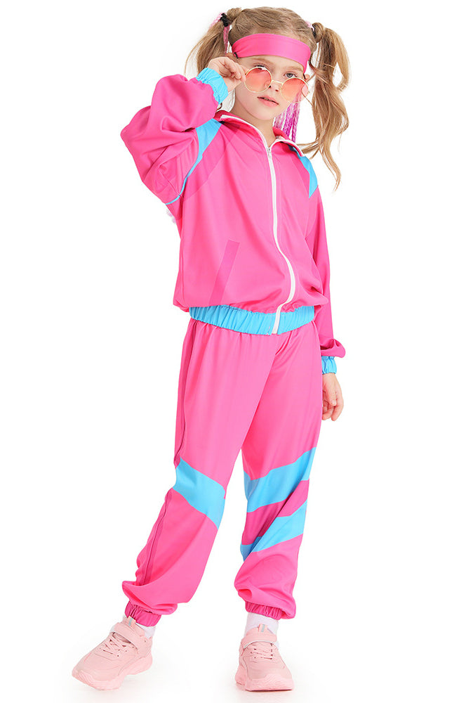 Child wearing hot pink 80s shell suit costume with turquoise chevron pants and matching headband