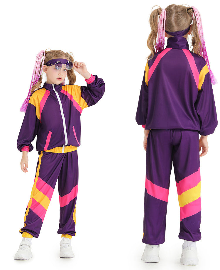 Child wearing purple 80s shell suit costume with pink and yellow color blocking, white zipper jacket and matching tracksuit pants