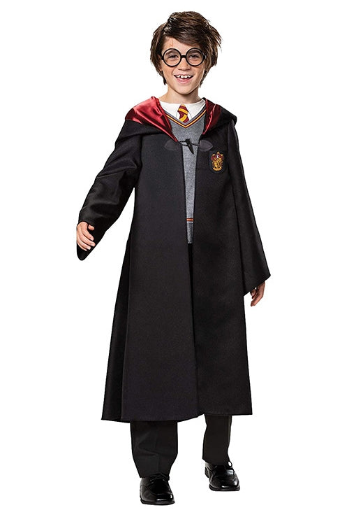 Child wearing black wizard school robe with red lining and house crest over grey printed top