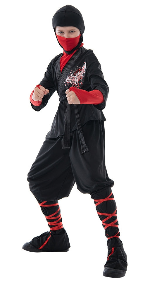 Child wearing black ninja warrior costume with red face mask and hooded head cover