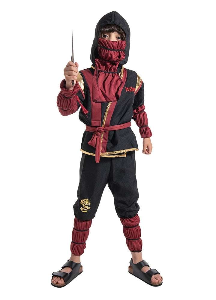 Child wearing black ninja warrior costume with red face mask and arm guards