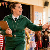 Australian primary-school teacher dressed as Miss Trunchbull from Matilda holding a clipboard at the front of a Book Week parade lineup