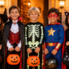 Group of kids in Halloween costumes trick or treating