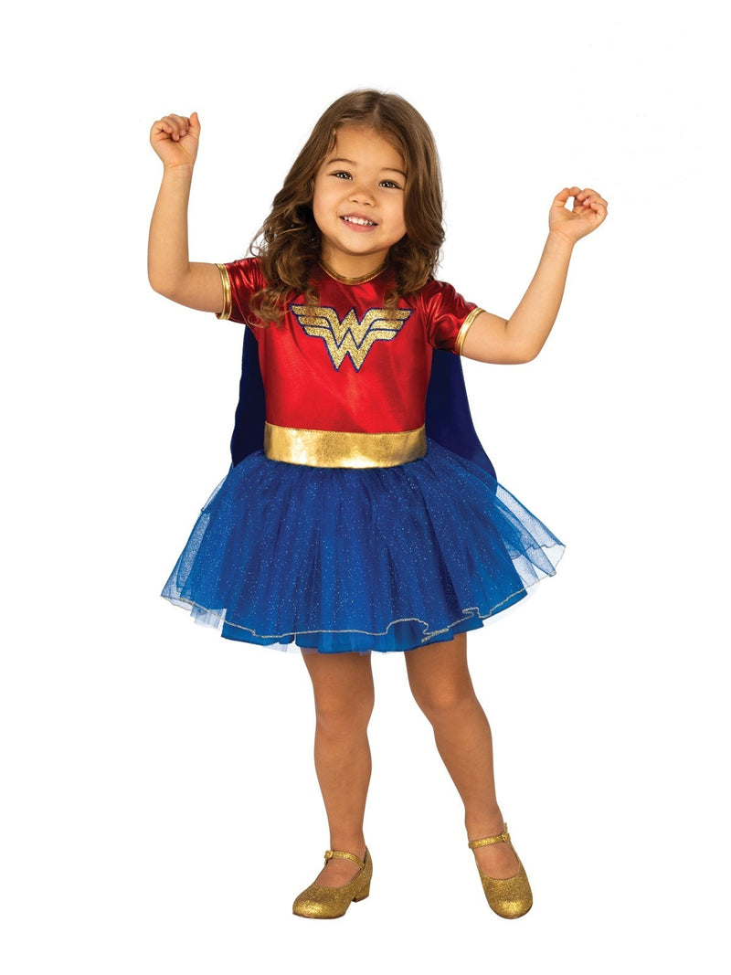 Toddler girl wearing red and blue Wonder Woman costume dress with gold logo and sparkly tutu skirt