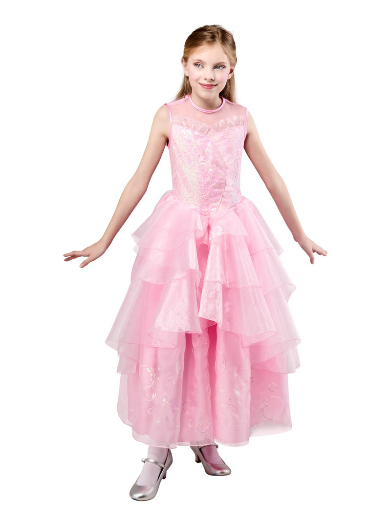 Child wearing pink Wicked Glinda dress with layered organza ruffles and mesh collar