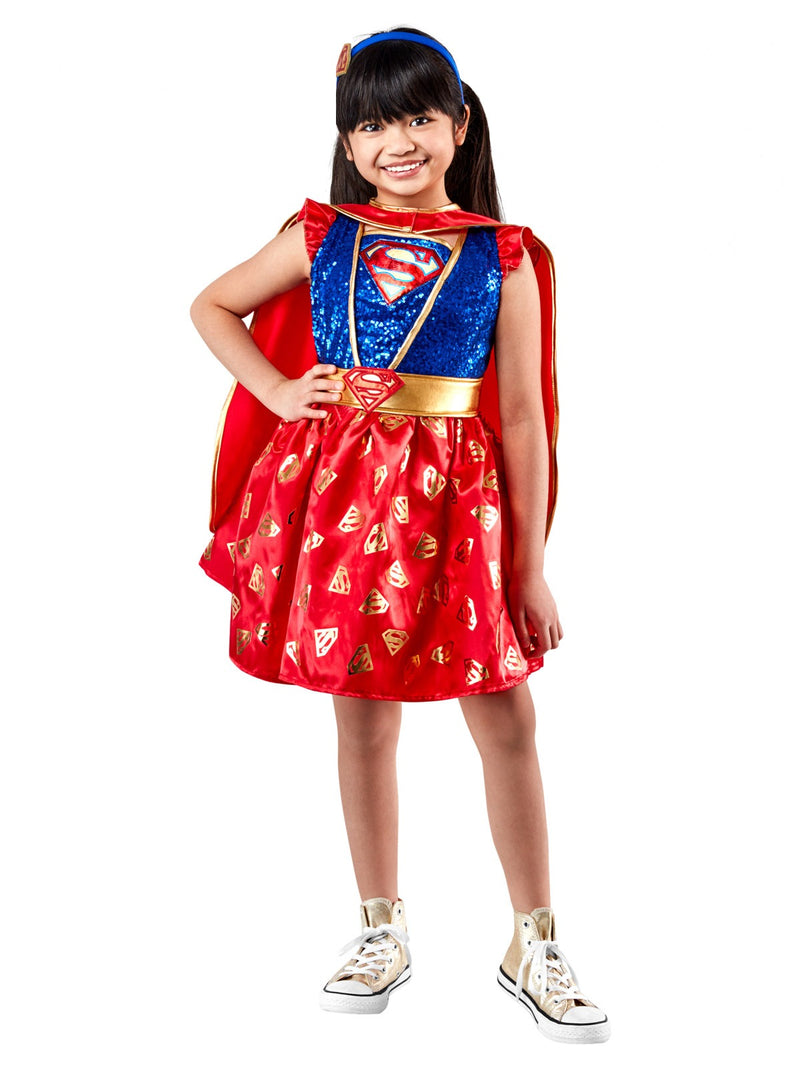 Girls Supergirl costume with sequined blue bodice, red tutu skirt with gold logo print, and detachable cape