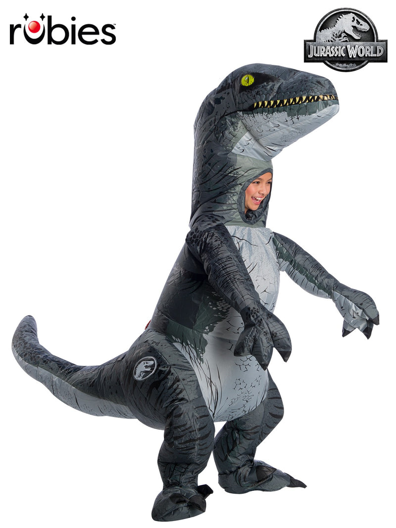 Child wearing Velociraptor Blue inflatable costume from Jurassic World, showing metallic blue stripe and oversized dinosaur head
