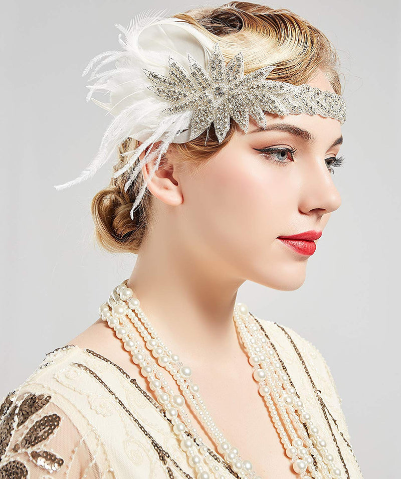 Ivory 1920s feather headband with Art Deco rhinestone medallion and ostrich plume on white background