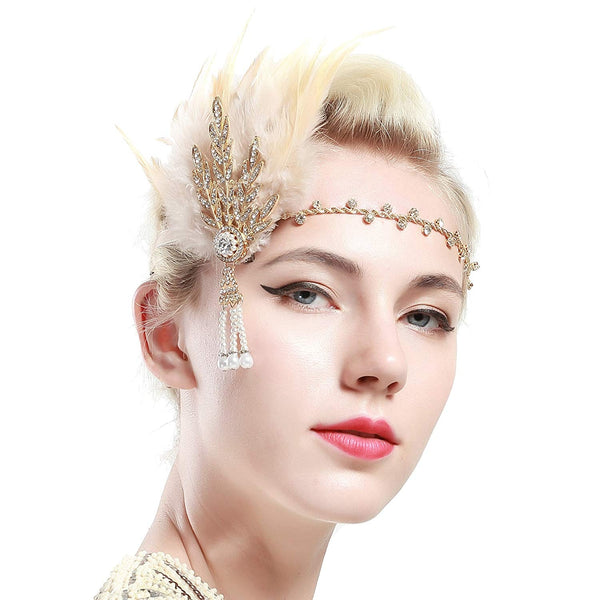 Adult 1920s flapper headpiece with gold feather plume and Art Deco jeweled brooch on white background