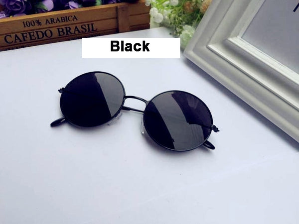 Round black wire-frame retro sunglasses with dark tinted lenses on white background