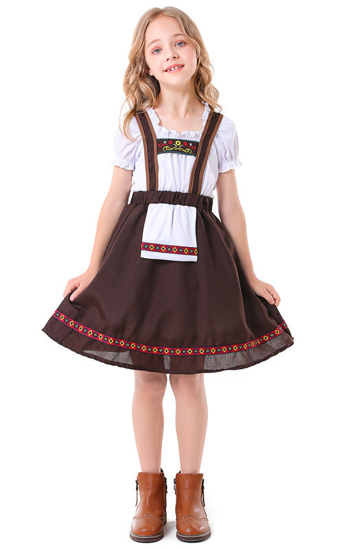 Girl wearing traditional Bavarian costume with white peasant blouse and brown suspender skirt with geometric trim