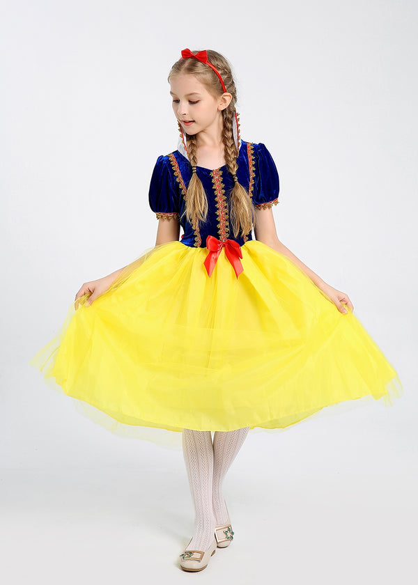 Child in blue velvet and yellow tulle fairytale princess dress with red bow headband